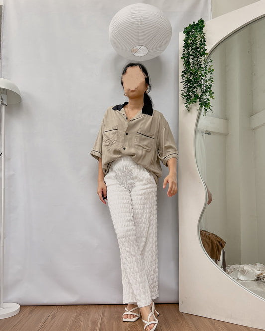 GU grayish brown button down top with brown collar and black hemline