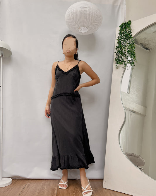 black maxi dress with curled ruffle hemline