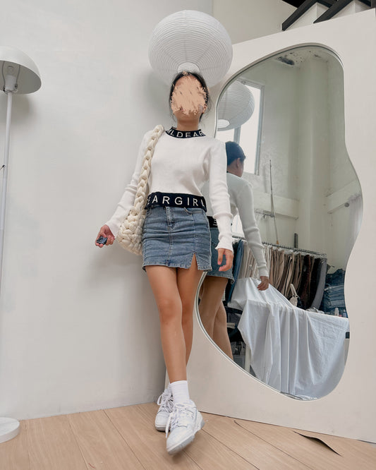 white pullover with black hemline
