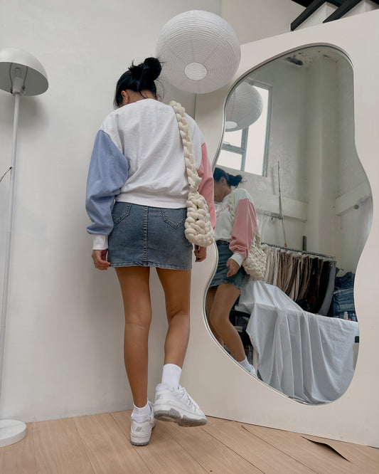 white pullover with blue and pink sleeves