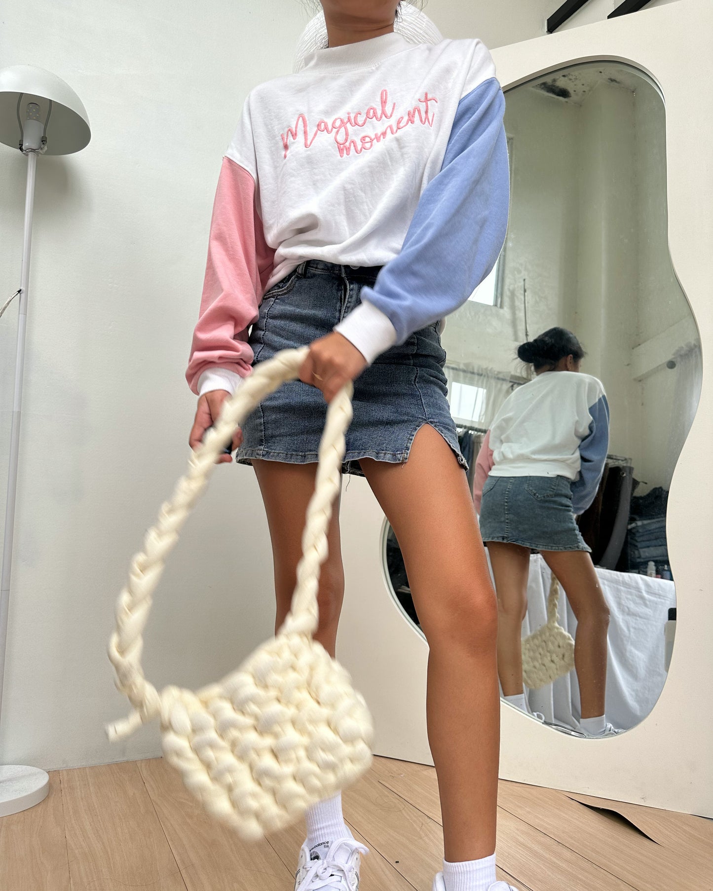 white pullover with blue and pink sleeves