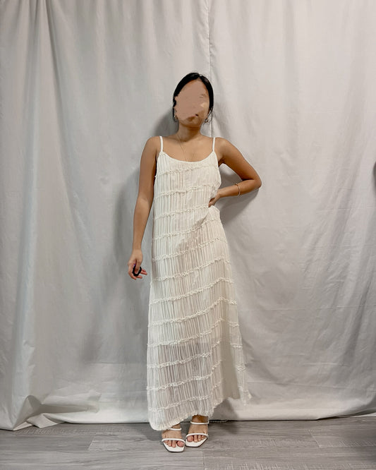 white sleeveless pleated dress with back slit