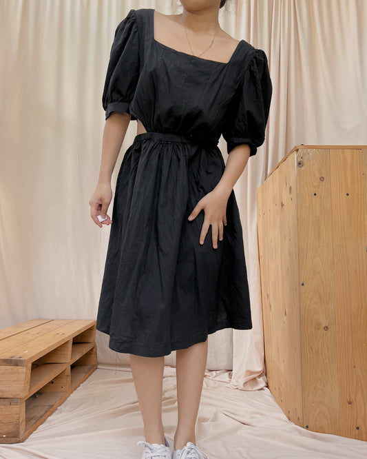 black dress with oversize sleeves and side waist  cut out