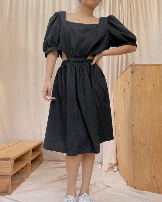 black dress with oversize sleeves and side waist  cut out