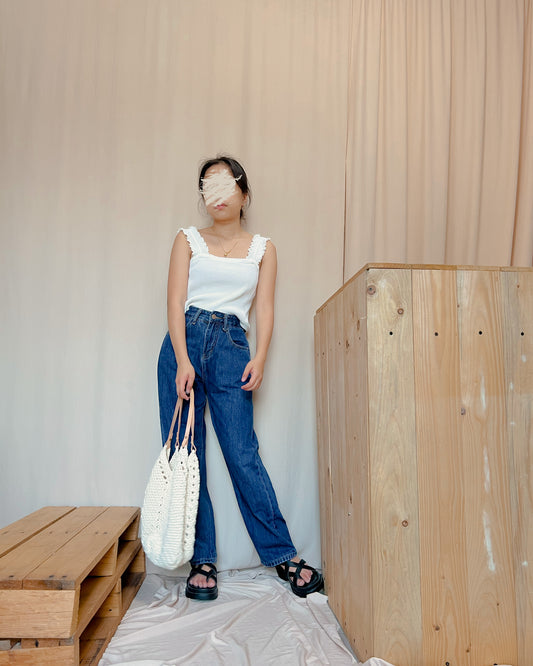 white ribbed knit top with curled hemline strap