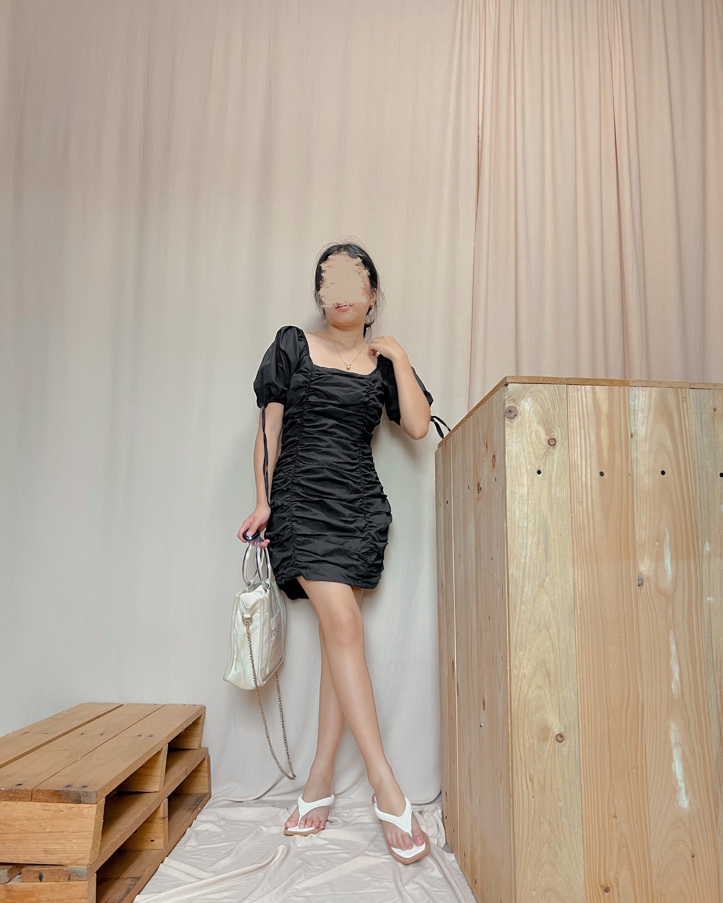 black mini dress with puff sleeves and ties